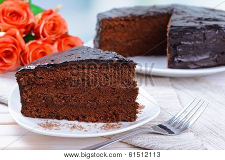 Delicious chocolate cake on plate on table close-up