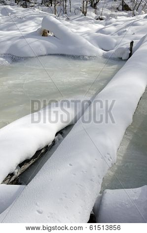 Frozen river in the winter forest. One of the tributaries of Lake Baikal