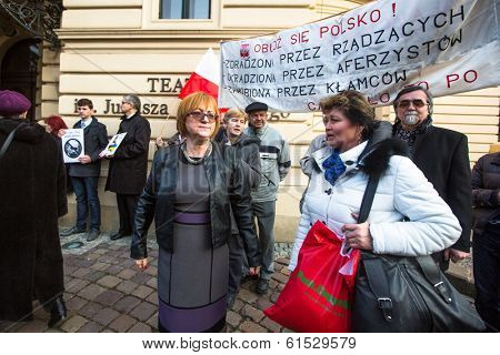 KRAKOW, POLAND - MAR 9, 2014: Unidentified participants during protest near Cracow Opera, against bringing Russian troops in the Crimea. Posters: Ukraine without Putin, and Putin - Thief.
