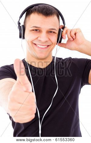 Smiling Handsome Man Listening To Music Showing Thumbs Up