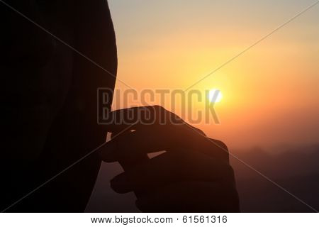 watching the sunset, head and hand silhouette