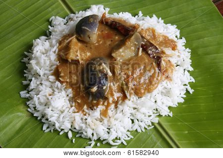 Brinjal sambar with rice on Banana Leaf