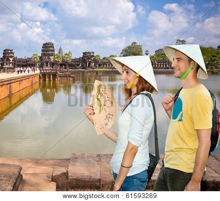 Beautiful young couple at  Angkor Wat temple complex, near Siem Reap, Cambodia.