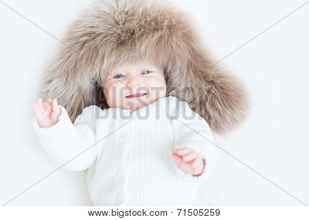 Sweet Laughing Baby In A Big Fur Hat
