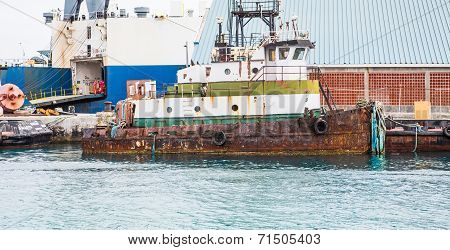 Old Rusty Tugboat At Dock