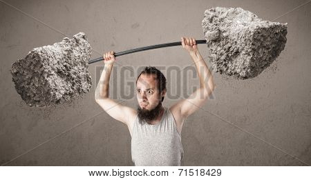 Funny skinny guy lifting large rock stone weights