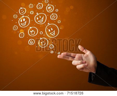 Group of happy hand drawed smiley faces coming out of gun shaped hands