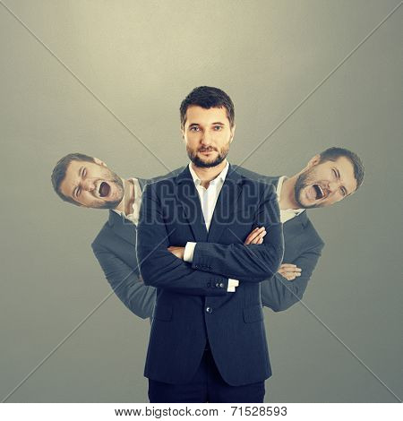 two screaming men behind confident businessman in suit over dark background