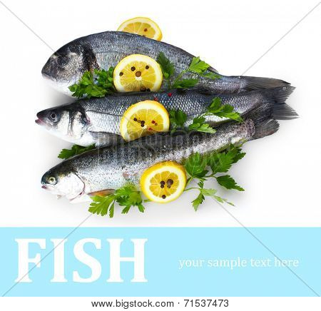Fresh fishes with lemon, parsley and spice isolated on white