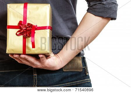 Holiday. Man Hiding Surprise Gift Box Behind Back
