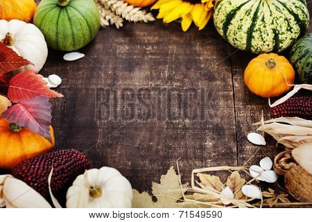 Autumn frame from pumpkins and corn on old wooden table. Thanksgiving day concept 