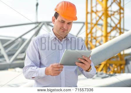 A Foreman With Digital Tablet At The Construction Supervising The Project.