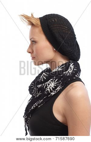 Profile of trendy young woman in sleeveless top, scarf and cap.