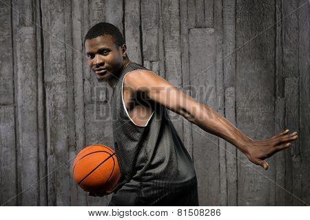 Afro-american muscular man with basketball