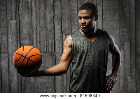 Afro-american muscular man holding basketball