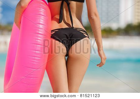 Beautiful woman on a tropical beach with a lifeline.