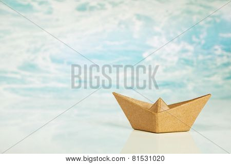 One brown paper boat isolated on a ocean or water background for concepts.