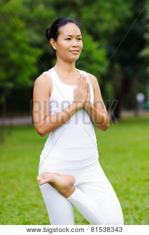 Beautiful Woman Practicing Yoga In The Park