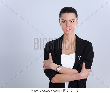 A young woman standing, isolated on graybackground