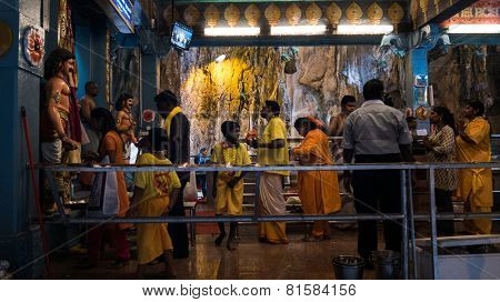 KUALA LUMPUR, MALAYSIA - JANUARY 31, 2015: Hindu devotees perform prayers at the Sri Mahamarriamman temple inside Batu Caves. Hundreds of thousands of devotees come here for the Thaipusam prayers.