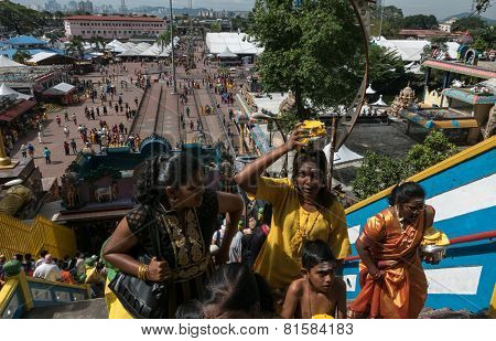 KUALA LUMPUR, MALAYSIA - JANUARY 31, 2015: Hindu devotees walk up the Sri Mahamarriamman temple built inside a limestone cave. Hundreds of thousands of devotees gather here for the Thaipusam prayers.