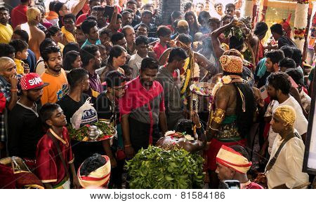 KUALA LUMPUR, MALAYSIA - JANUARY 31, 2015: Hindu devotees perform prayers at the Sri Mahamarriamman temple inside Batu Caves. Hundreds of thousands of devotees come here for the Thaipusam prayers.
