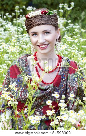 Happy Smiling Russian Woman Sitting In The Field