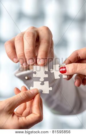 Conceptual Human Hand Holding Puzzle Pieces