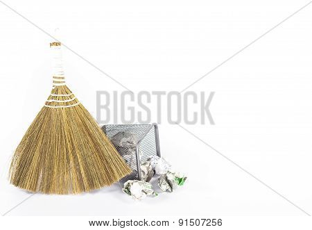 isolated besom and wastebasket with white waste paper