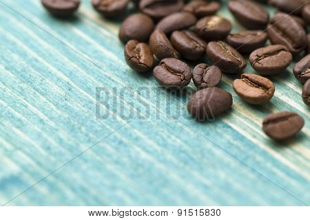 Coffee beans on the blue wood background