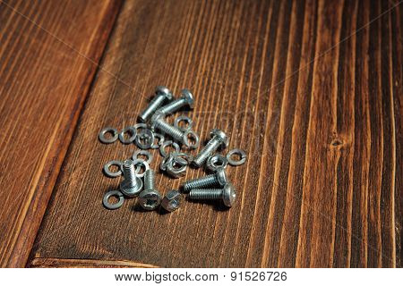 Screws On The Wooden Background