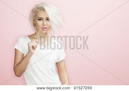 Portrait model with sunglasses a pink background