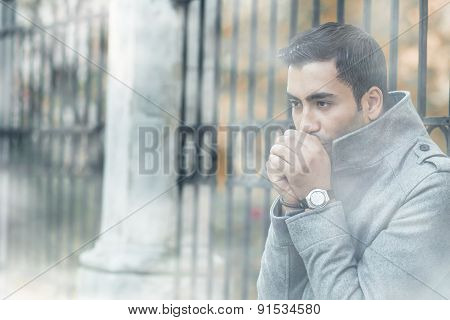 Young Man Blowing Into Their Hands Or Heats Hands, Coldly Morning With Fog