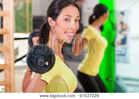 Pretty young woman practicing in the gym
