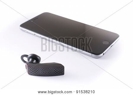 Modern Wireless Jawbone Bluetooth Headset With An Iphone