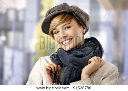 Attractive young woman in winter clothes, smiling.