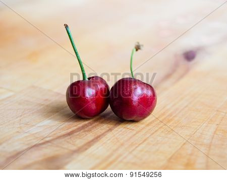 Pair of cherries on a plank