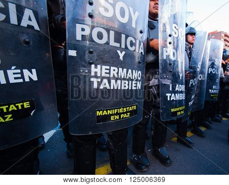 Quito, Ecuador - April 7, 2016: Police awaiting overlooking peaceful anti tax march in Shyris Avenue. Anti Rafael Correa goverment protestors.
