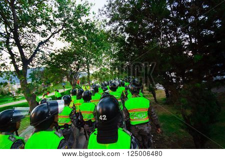 Quito, Ecuador - April 7, 2016: Police leaving marching peaceful anti tax march in Shyris Avenue with anti Rafael Correa goverment protestors.
