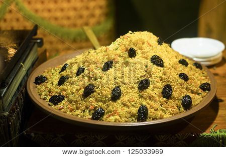 Large bowl of couscous with dried plums