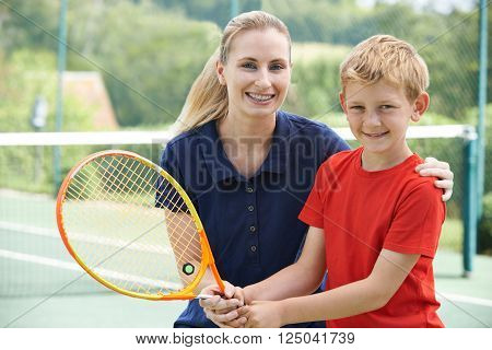 Female Tennis Coach Giving Lesson To Boy
** Note: Shallow depth of field