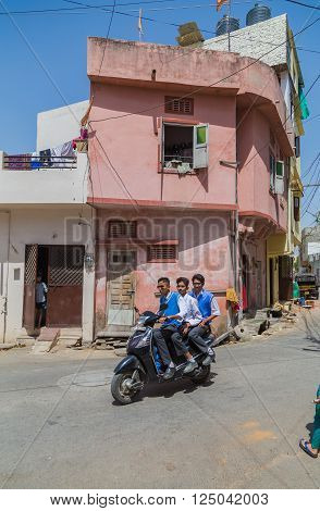 UDAIPUR INDIA - 21ST MARCH 2016: Streets scenes in Udaipur India during the day. Showing people motorbikes and buildings
