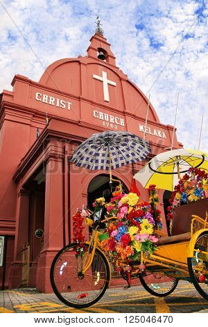 Two icons of Malacca Malaysia : The trishaw or beca and Christ Church