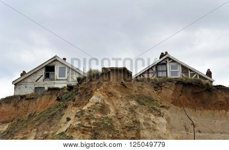 Homes in danger on the cliff edge at Happisburgh in Norfolk demonstrating levels of erosion along the East Coast. UK.