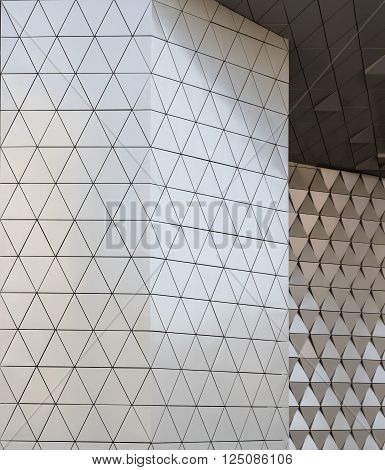 Abstract close-up view of modern aluminum ventilated facade of triangles
