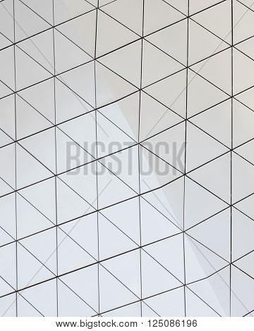 Abstract close-up view of modern aluminum ventilated facade of triangles