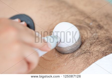 Applying an ultrasonic sound (Ultrasound) Treatment on male patient