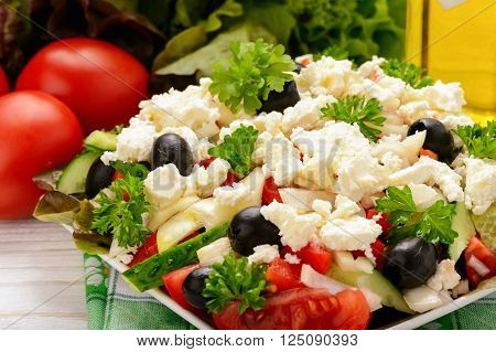 Vegetable salad with tomatoes, cucumbers, oilves and feta cheese -bulgarian traditional summer salad.