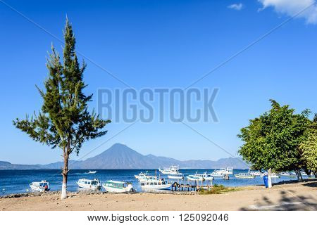 Boats & San Pedro volcano on Lake Atitlan in Guatemalan highlands