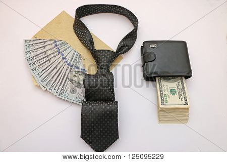composition of objects as a purse full of bills an envelope filled with cash tie semiautomatic weapons.